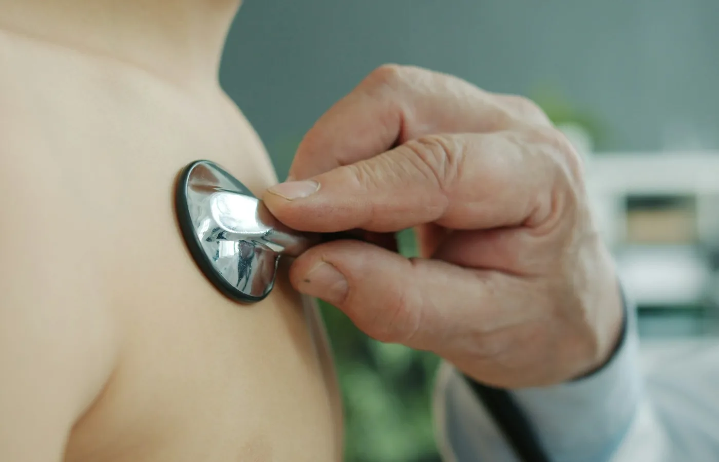 Cardiologist examining a patient with a stethoscope